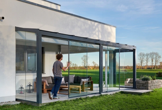 Åben og stilren udestue i glas, med udsigt til haven, fra Solarlux 